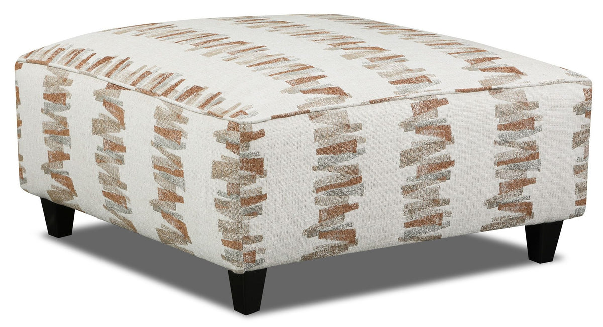 A square upholstered ottoman with a cream fabric covered in vertical abstract brushstroke patterns in warm brown and beige, supported by four short black legs.