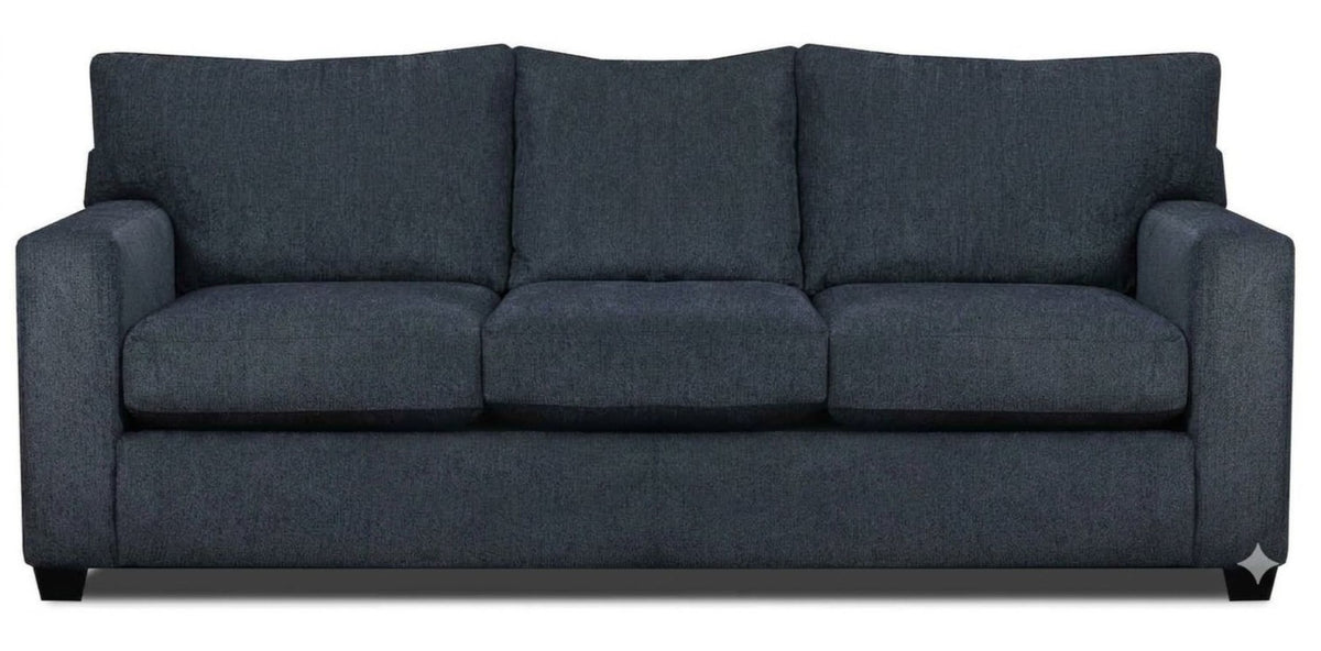 A three-seat sofa upholstered in denim blue fabric atop espresso stain feet.