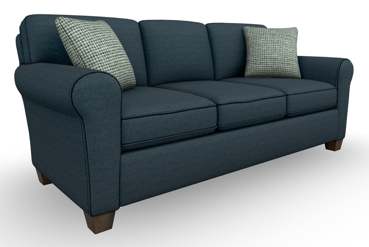 A three-seat sofa upholstered in marine blue fabric atop espresso stain wooden feet.