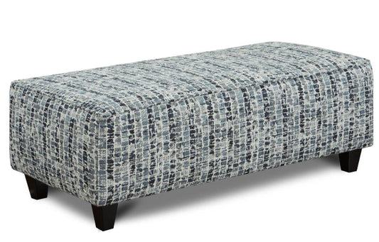 A rectangular cocktail ottoman with fabric upholstery in a navy slate and gray modern check with an off white background.